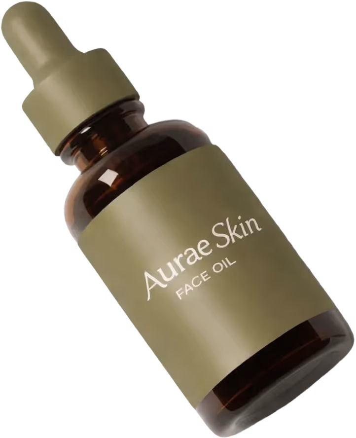 Amber glass bottle with olive green dropper cap and label reading Aurae Skin Face Oil.